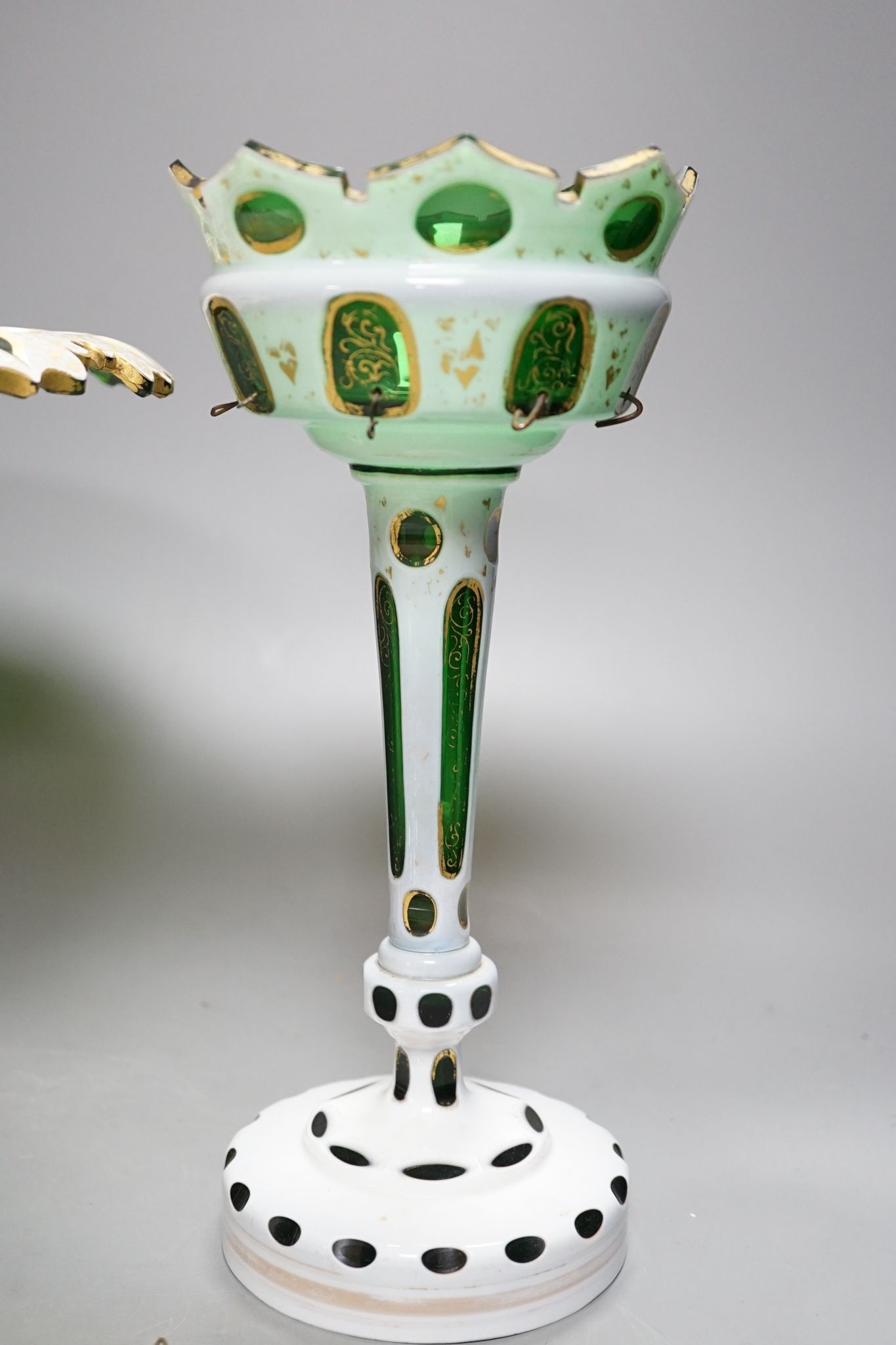 A 19th century overlaid green glass comport, 24cm high, and a similar table lustre